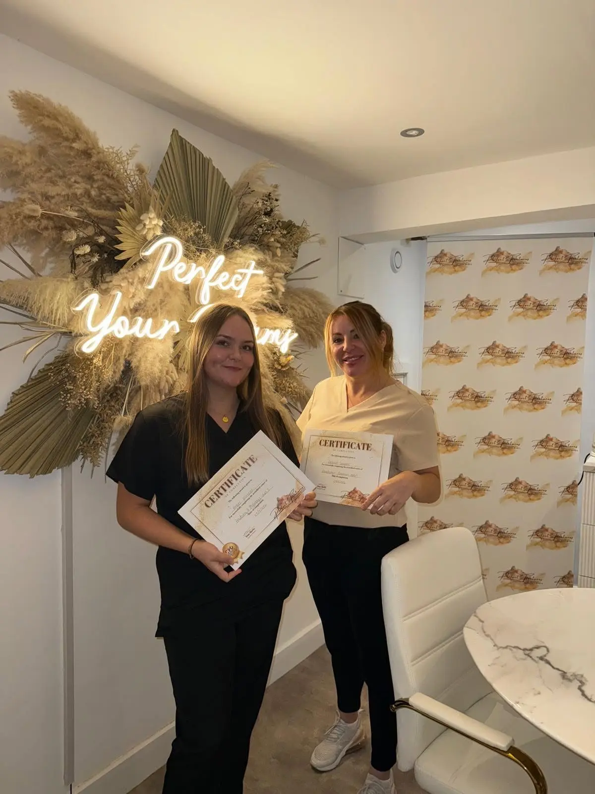 Student celebrating completion of aesthetics training course in Stalybridge